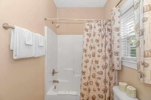 a bathroom with a toilet and a shower curtain at Spacious 4 Bedroom House-2 Blocks From the Ocean-2185 Sanibel Court! in Myrtle Beach