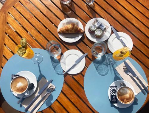 a table with a cup of coffee and a plate of food at Sa Nau Agroturismo - Adults Only over 16 in Portocolom