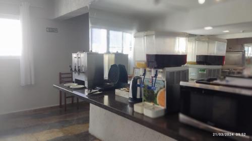 a kitchen with a counter top in a kitchen at Hotel Imperador in Santos