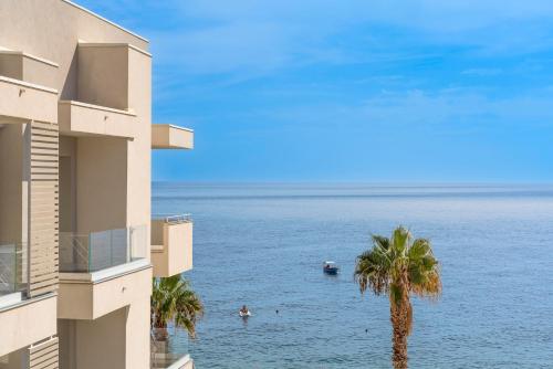 a view of the ocean from a building at Albatros Beach Hotel in Letojanni