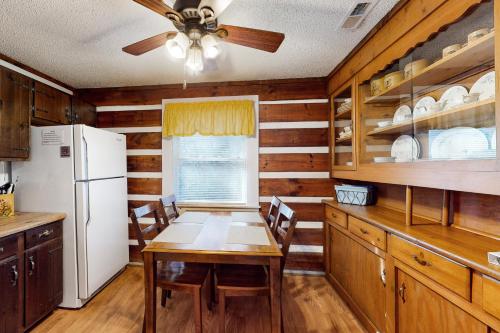 a kitchen with a table and a white refrigerator at 2 Bed 2 Bath Vacation home in Whittier II in Whittier