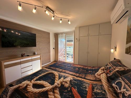 a bedroom with a large bed with a large window at Villa Anthony in Rovinj