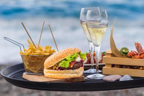a sandwich and french fries and a glass of wine at Albatros Beach Hotel in Letojanni