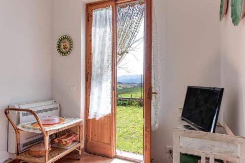 a room with an open door with a window at Relax in Campagna - Mugello Circuit in Scarperia