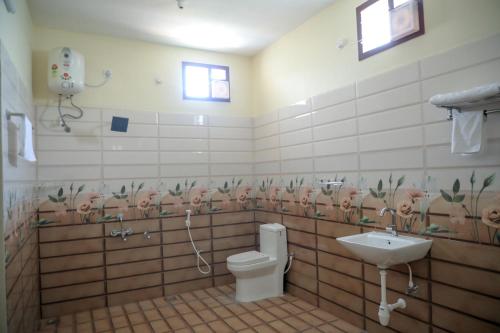 a bathroom with a toilet and a sink at Paradise Home Stay Pondicherry Luxury Stay with Private Swimming Pool in Auroville