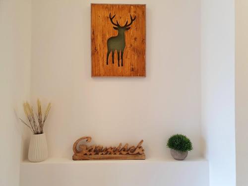 a picture of a deer on a wall at Ferienhaus Berger mit eigenen Whirlpool im Garten in Garmisch-Partenkirchen