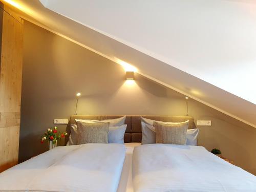 two beds in a room with a staircase at Ferienhaus Berger mit eigenen Whirlpool im Garten in Garmisch-Partenkirchen