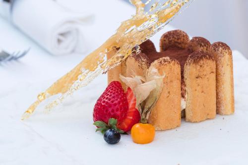 a piece of bread with a strawberry and other fruits at Albatros Beach Hotel in Letojanni