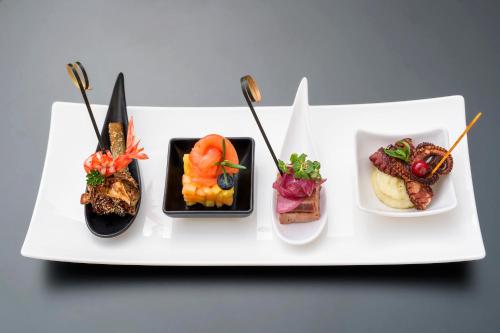 a white plate with different types of food on it at Albatros Beach Hotel in Letojanni