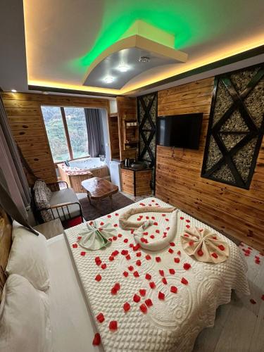 a room with a table with red roses on it at Peruma otel bungalov in Çamlıhemşin