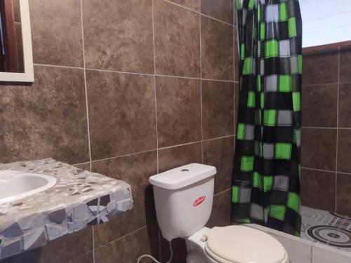 a bathroom with a toilet and a sink at Grand Selva Lodge & Tours in Tena