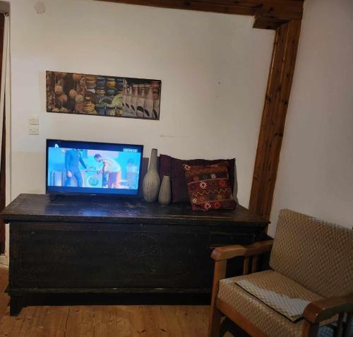a television sitting on top of a dresser in a room at Traditional farmhouse in Alexandros