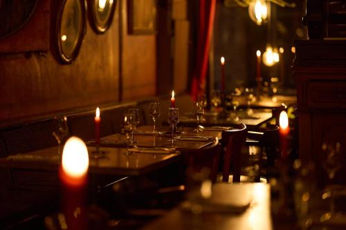 a table with lit candles on top of it at Gran Hotel De Passage in Bruges