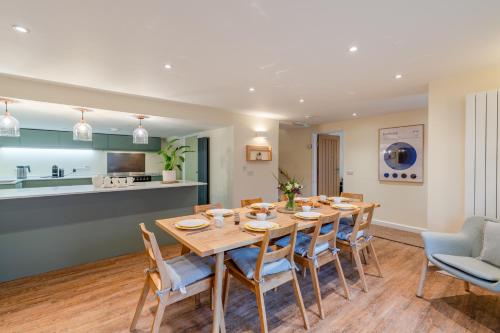 a kitchen and dining room with a wooden table and chairs at The Weir House in Symonds Yat