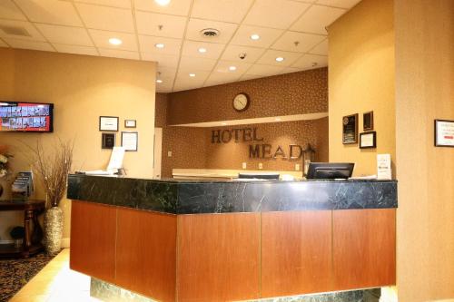 a hotel lobby with a hotel melaka sign on the wall at Hotel Mead Resorts & Conventions Center in Wisconsin Rapids