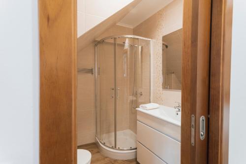 a bathroom with a shower and a toilet and a sink at Best Houses 77 - Best Village I in Peniche