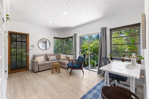 a living room with a couch and a table at Delight and cozy Apt close to Las Olas & the beach in Fort Lauderdale