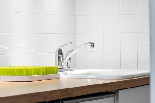 a kitchen sink with a green sponge on it at Delight and cozy Apt close to Las Olas & the beach in Fort Lauderdale