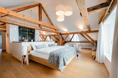 Oberdorf的住宿－Hotel Weissenstein，一间卧室设有一张大床和木制天花板。