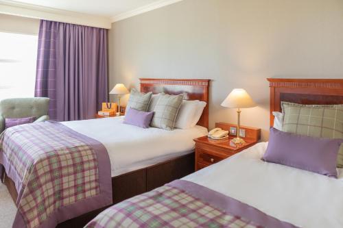 a hotel room with two beds and a chair at Knightsbrook Hotel & Golf Resort in Trim