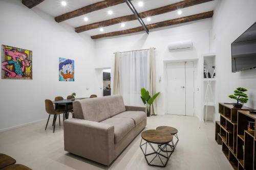 a living room with a couch and a table at Napolidays Rua Catalana Apartment in Naples