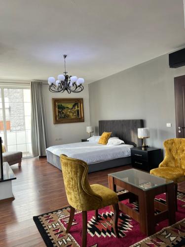 1 dormitorio con 1 cama, mesa y sillas en North Star Hostel, en Shkodër