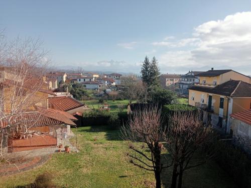 a view of a city with houses and trees at San Quirico Locanda ristorante pizzeria in Barbarasco