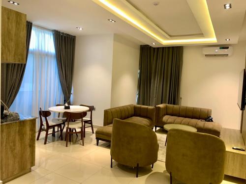ein Wohnzimmer mit einem Sofa, Stühlen und einem Tisch in der Unterkunft Polo Grand Hotel in Maiduguri