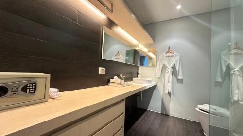 a bathroom with a sink and a counter with a microwave at Veranda Residence pattaya By Sea in Jomtien Beach