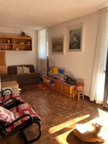 a living room with a couch and a table at Casa Polly a Saint Rhemy En Bosses in Saint-Rhémy-en-bosses