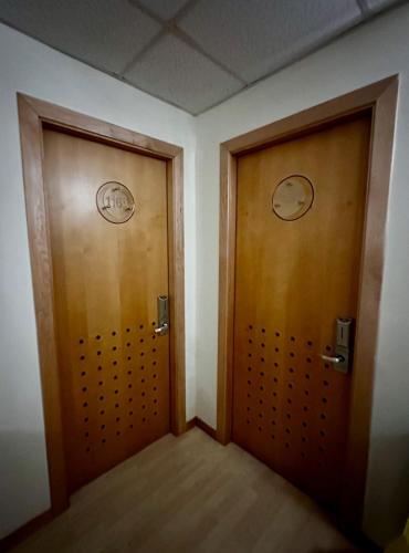 two wooden doors in a room with at Hotel Ponte Molo in Porto Tolle