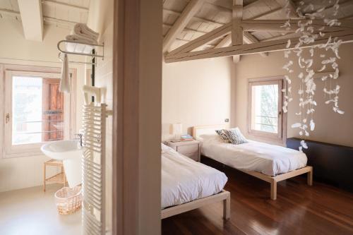 a bedroom with two beds and a sink in it at FARM HOUSE in Roncade