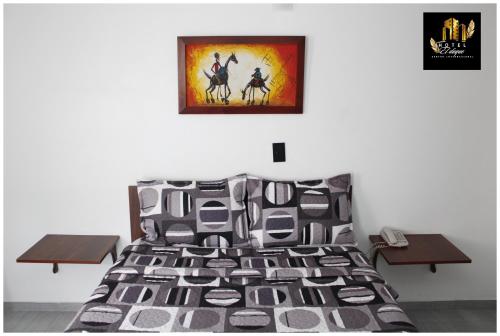 a bedroom with a bed and a picture on the wall at Hotel el Duque Internacional, Bogotá in Bogotá