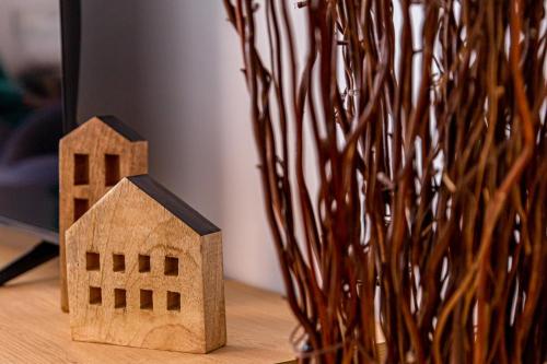a wooden model of a house next to a vase at Azul Studio Preveza in Preveza