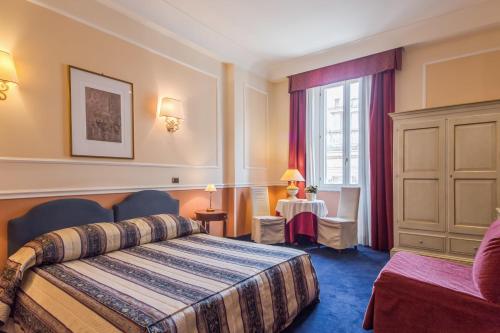 a hotel room with a bed and a window at Relais Hotel Antico Palazzo Rospigliosi in Rome