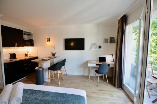 Habitación con cama, escritorio y cocina. en Studio pour séjours d’affaires à La Défense, en Courbevoie