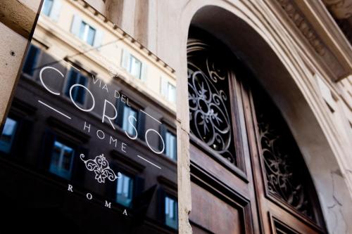 a door of a building with a sign on it at Via Del Corso Home Roma in Rome