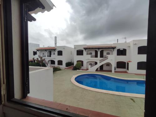 a view from a window of a house with a swimming pool at Apartamento Menorca son parc in Son Parc