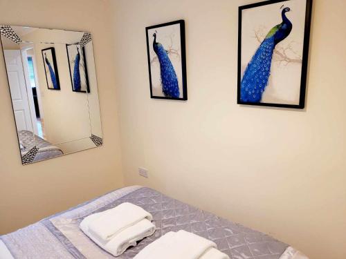 a bedroom with a bed and two mirrors at Apartment 2 in Darlington
