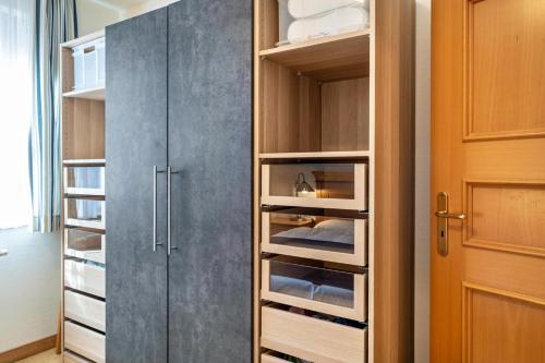 a walk in closet with a gray door at Oewern Diek in Wustrow
