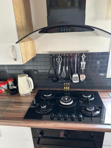 a stove top oven in a kitchen with utensils at 13 Chorley close in Walton-on-the-Naze