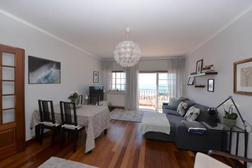 a living room with a couch and a table at Atlantic Dream View - Apartment for 4 with amazing sea views in great location in Nazaré