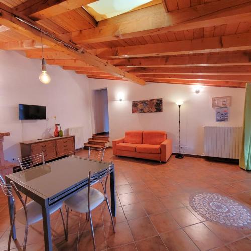 a living room with a table and a couch at Il nido in montagna Mountain Lake Iseo Hospitality in Bossico
