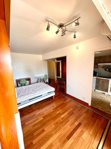 une chambre avec un lit et un parquet dans l'établissement Aimé Marin - Studio - Belle résidence avec terrasse et piscine, à Nice