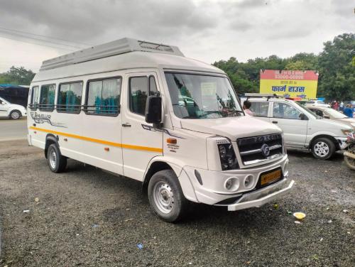 a white van parked in a parking lot at Gehelot DharmShala in Ujjain