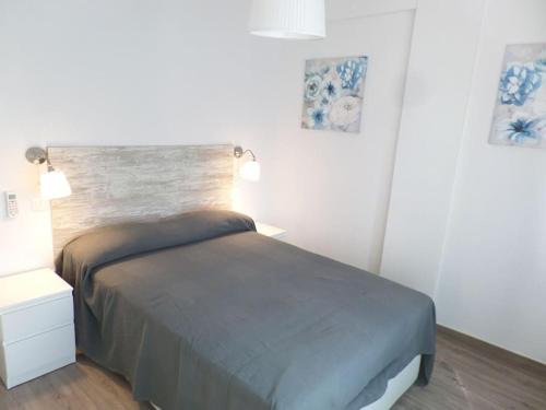 a bedroom with a bed and two night stands and two lamps at Room City Estepona Castillo in Estepona