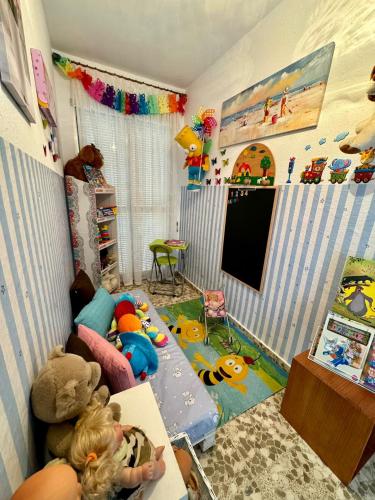 a childrens room with a tv and toys in it at La casa de mis padres in Júzcar