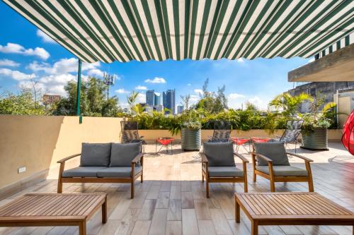 a patio with chairs and tables and a view of the city at VICENTE SUAREZ By Mr W in Mexico City
