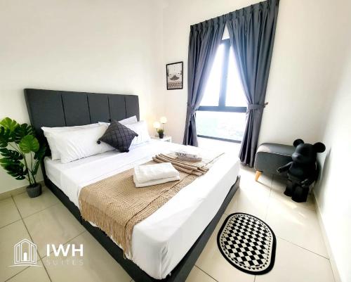 a bedroom with a large bed with a teddy bear on it at Ipoh Horizon Skypool Town Suites 4-11pax by IWH Suites in Ipoh