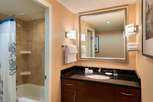 a bathroom with a sink and a shower and a mirror at Residence Inn by Marriott Toronto Downtown / Entertainment District in Toronto